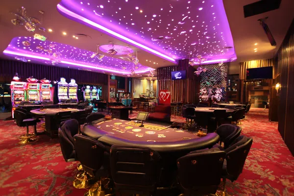 A man focused on his laptop with live stats in the background, highlighting the dedicated sports and gaming features of the PK66 mobile app.