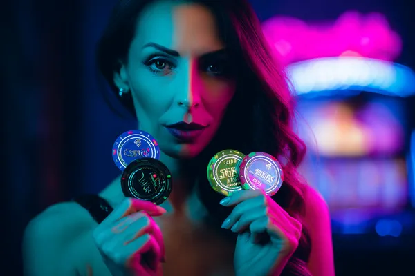 PK66 Slots — Thousands of thrilling machines await A woman smiling by bright slot machines showing lucky symbols, showcasing the exciting slot offerings at PK66.